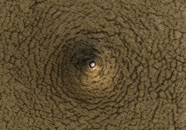 NASA Orbital Camera Captures Strange Cone-shaped Pit on Mars