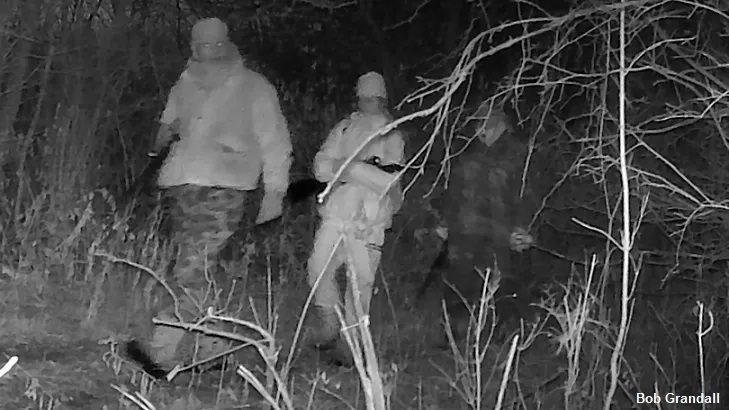 Trail Cam Photographs Ghostly Figure Following Pair of Hunters